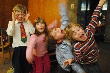 Four children laughing and smiling